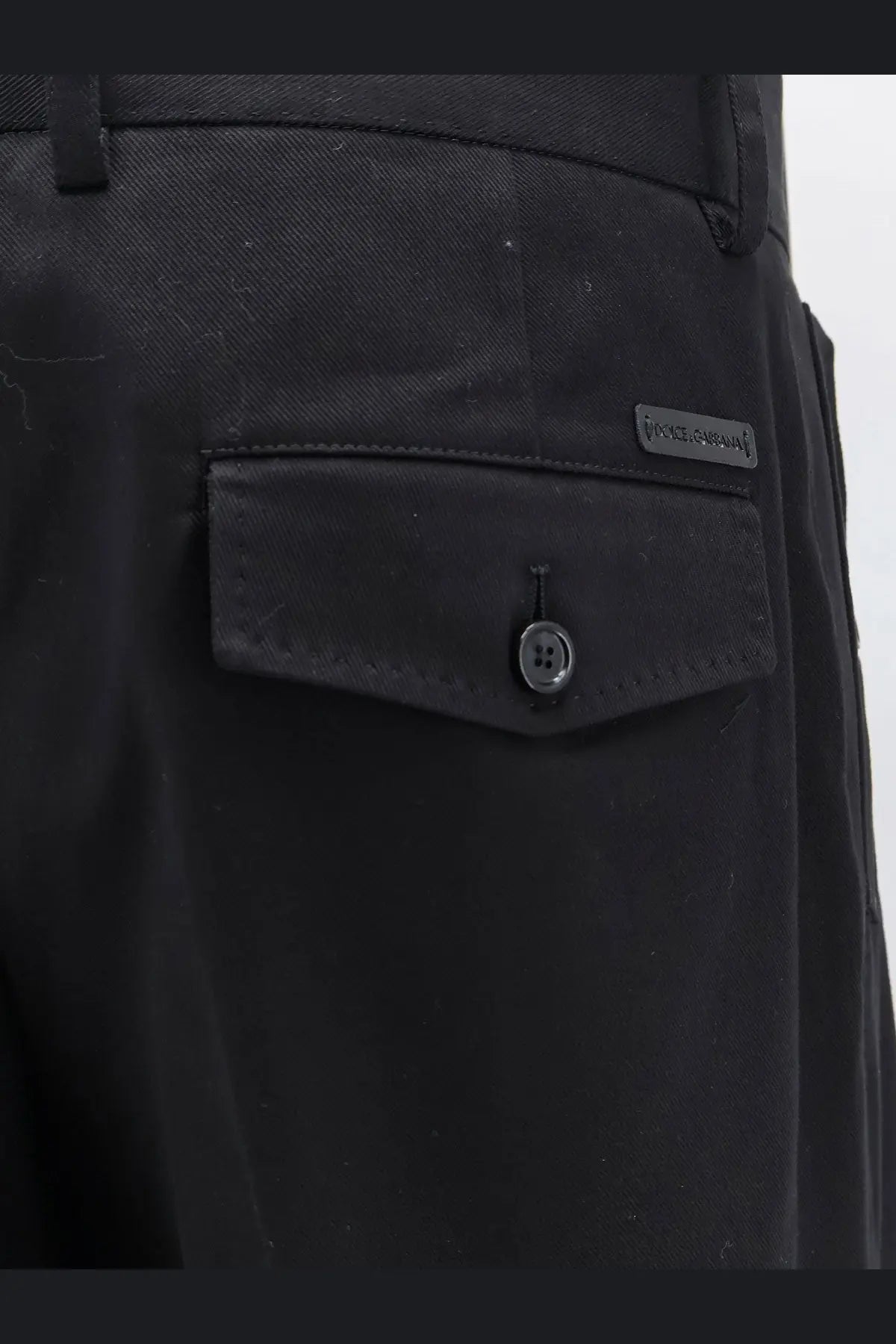 Black textured cotton trousers by Dolce &amp; Gabbana featuring a buttoned flap pocket with a subtle brand label