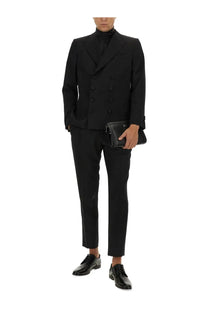 Black leather clutch with minimalist design and subtle branding paired with dolce &amp; gabbana men’s double breasted jacket black