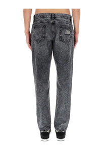 Dolce &amp; gabbana men’s jeans in denim black showing the back side with dark gray faded relaxed fit and classic pockets