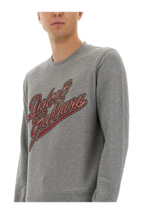 Dolce &amp; Gabbana men’s grey jersey sweatshirt with red and brown cursive logo across the chest