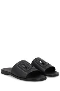 Dolce &amp; Gabbana men’s black leather slide sandals with prominent embossed logo on the strap