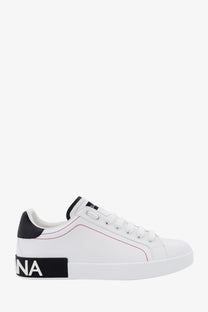 Dolce &amp; Gabbana men’s low top white leather sneakers with black heel tab sole branding and red stitching accents