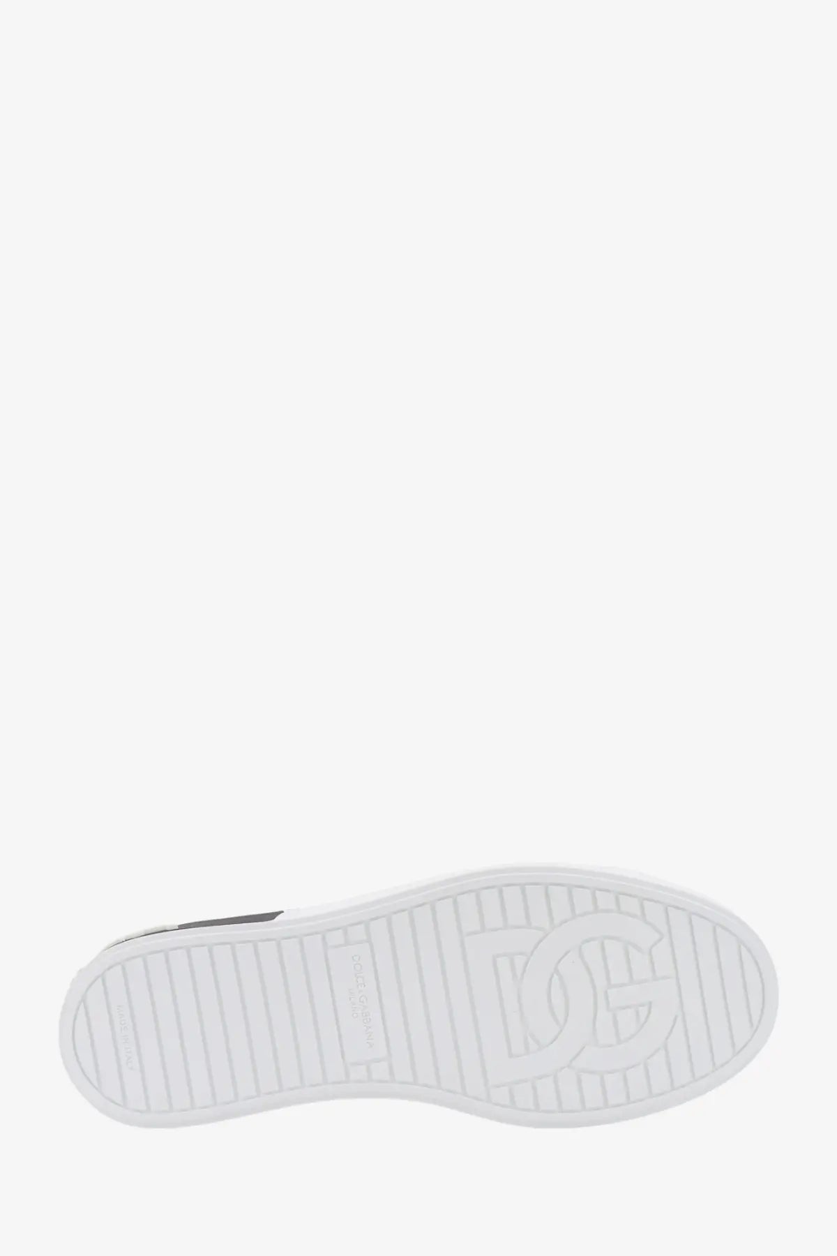 White rubber sole with embossed dg logo and textured grip on dolce &amp; gabbana men’s low top black leather sneakers