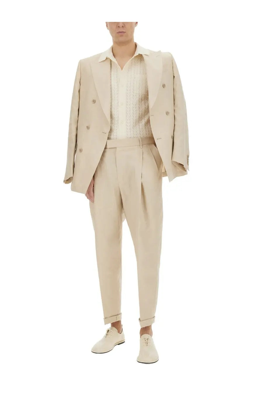 Beige double-breasted suit with pleated trousers and matching loafers paired with dolce and gabbana white perforated cotton knit shirt