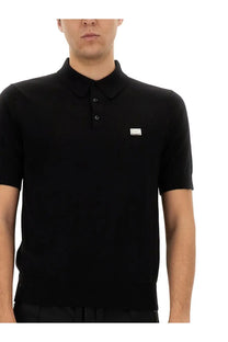 Dolce &amp; Gabbana men’s black short-sleeved polo shirt with subtle textured knit and silver logo patch on left chest