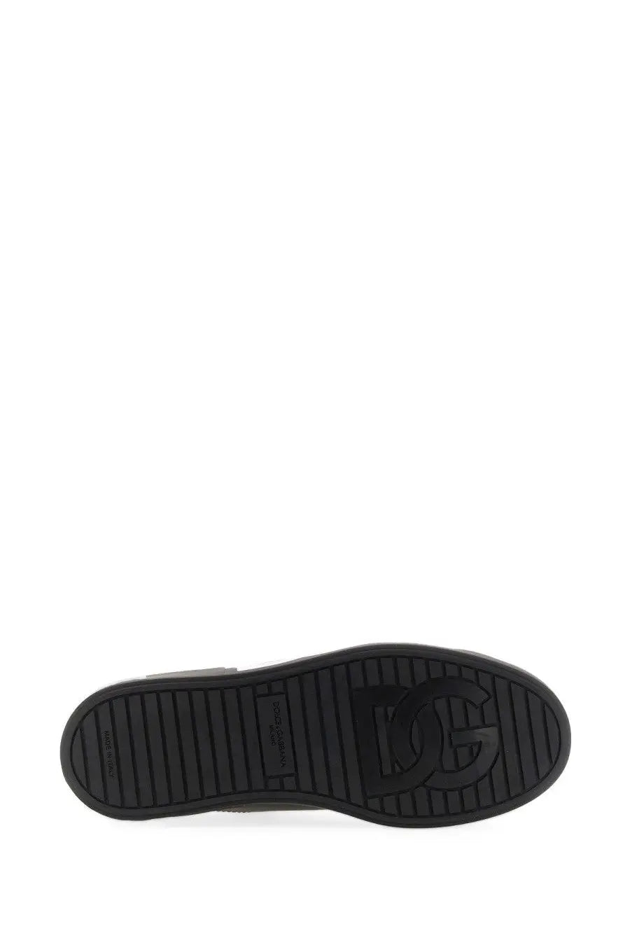 Black rubber sole with embossed dg logo and textured grip pattern on dolce and gabbana men’s portofino sneaker black