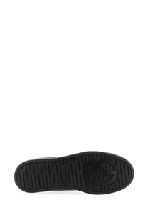 Black rubber sole with embossed dg logo and textured grip pattern on dolce and gabbana men’s portofino sneaker black