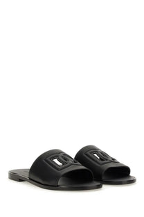 Dolce &amp; Gabbana men’s black leather slide sandals with prominent embossed interlocking logo design