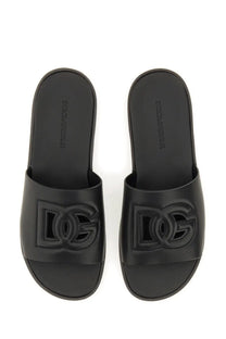 Dolce &amp; Gabbana men’s black slide sandals with bold embossed DG logo on the footbed for casual wear