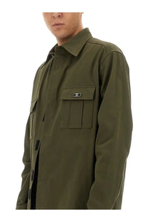 Dolce &amp; Gabbana men’s olive green utility shirt with structured collar, flap pockets, black logo patches, and button closures