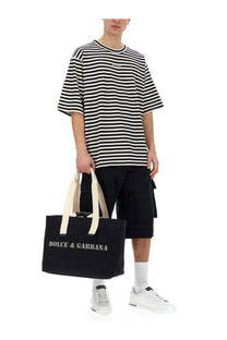 Black canvas tote bag with cream handles and white dolce and gabbana lettering for men multicolor shirt product