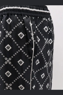 Dolce &amp; Gabbana men’s black silk trousers with dc logo print white stripes and piping detail