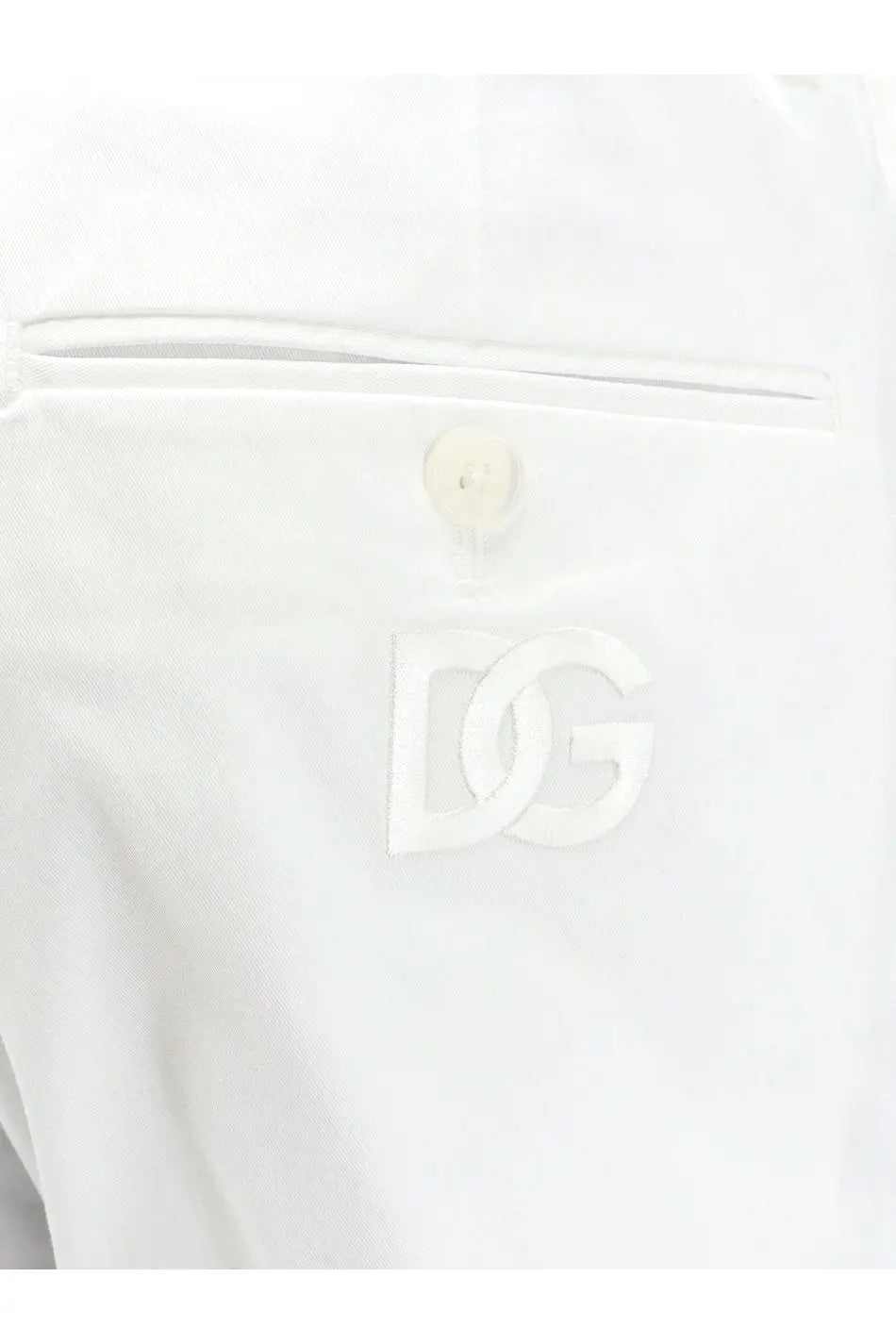 White dolce and gabbana dg logo patch on the white fabric pocket of men’s stretch cotton trousers