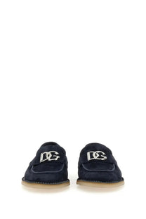 Dolce &amp; Gabbana men’s navy blue suede loafers with silver dg logo plaque featuring a sleek design