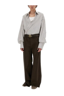 Black leather belt with gold tone dolce gabbana logo buckle paired with men’s super over shirt multicolor