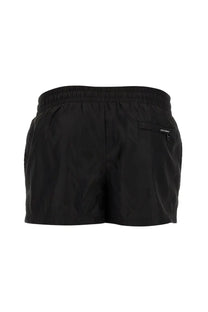Black dolce and gabbana men’s swimsuit showing back with elastic waistband and small zippered pocket