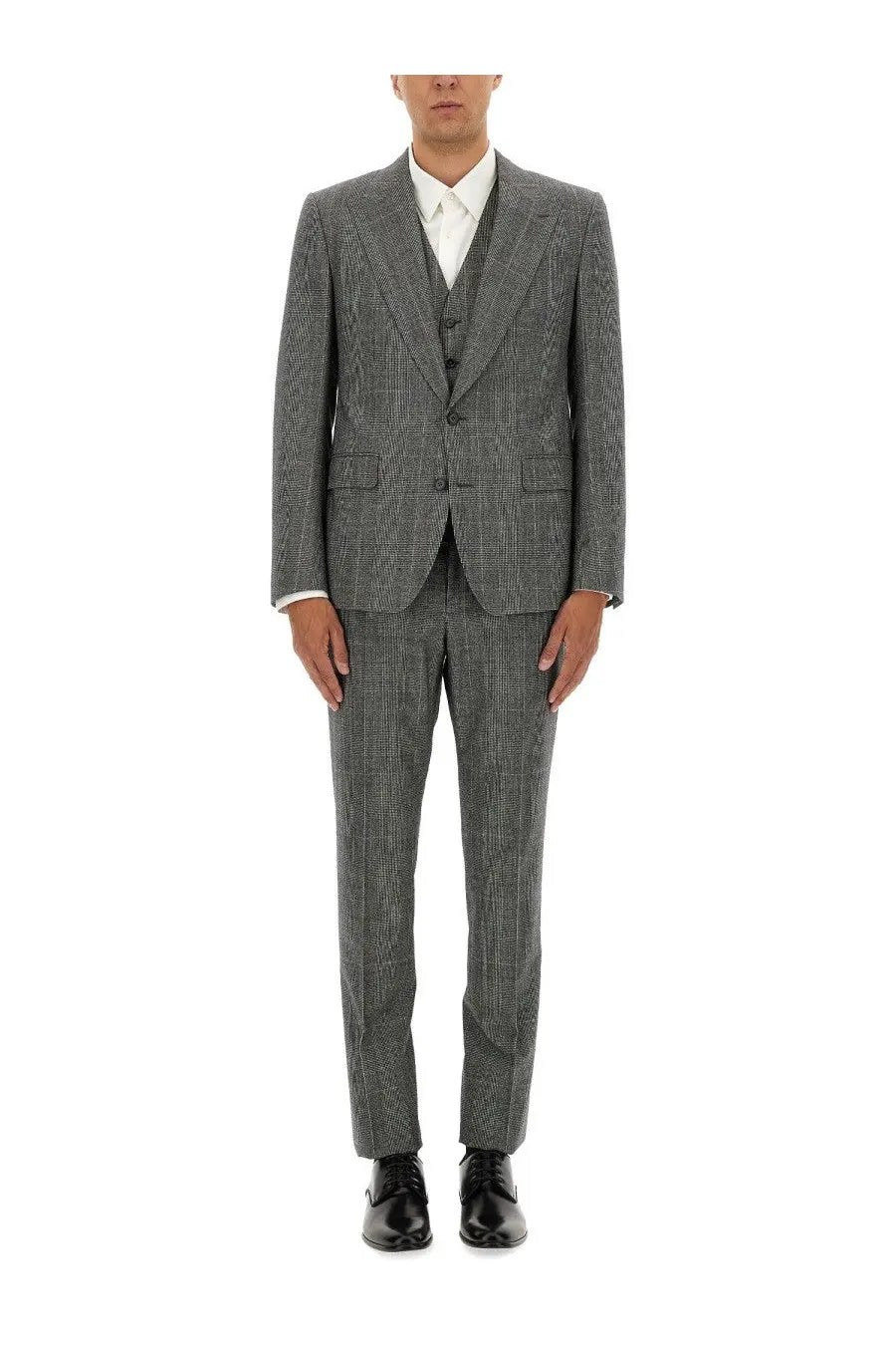 A man wearing a Dolce &amp; Gabbana men’s three piece grey checkered suit with matching trousers and a white dress shirt