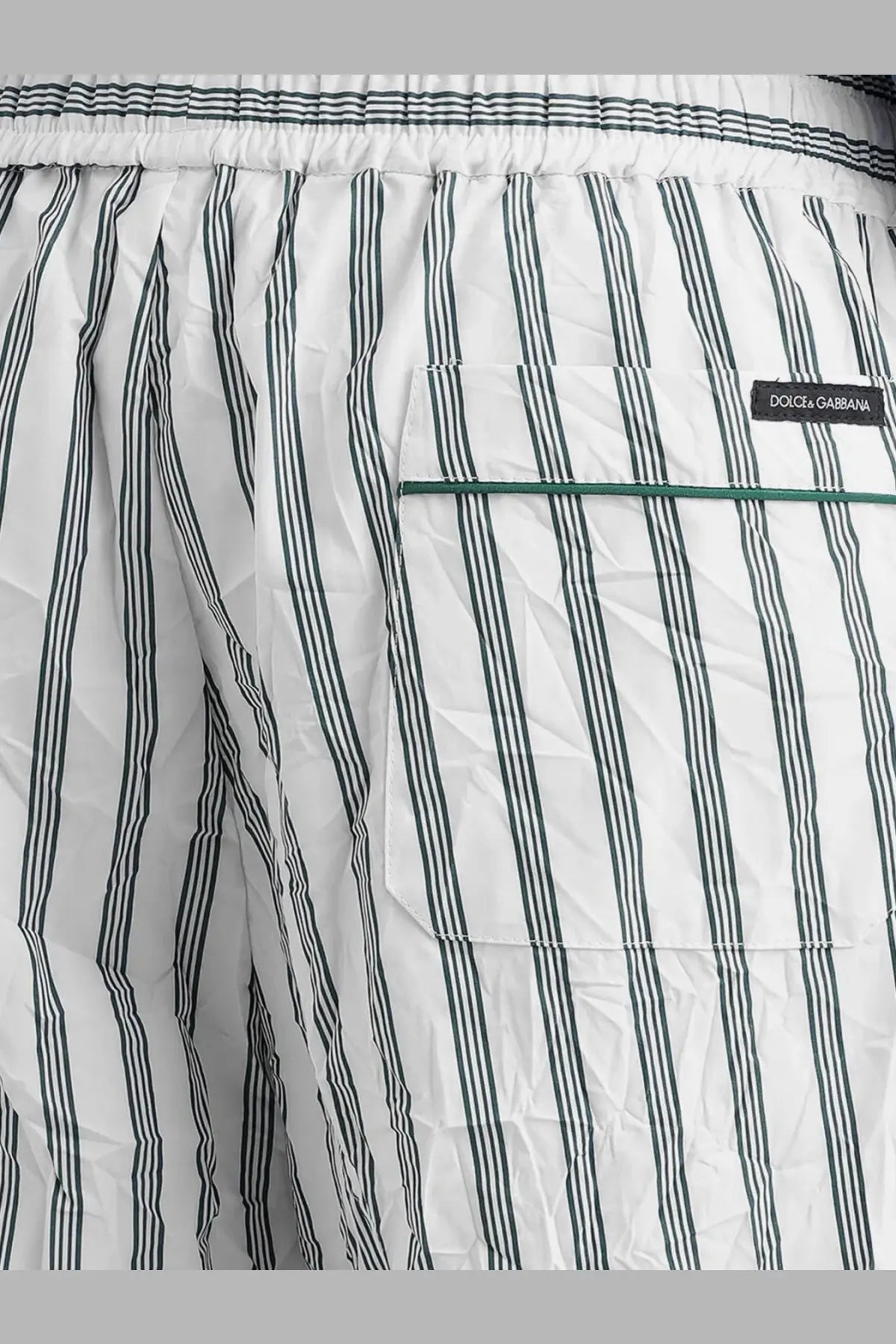 Dolce &amp; Gabbana men’s vanity swim trunks in white and dark green vertical stripes with matching pocket detail and froissé fabric