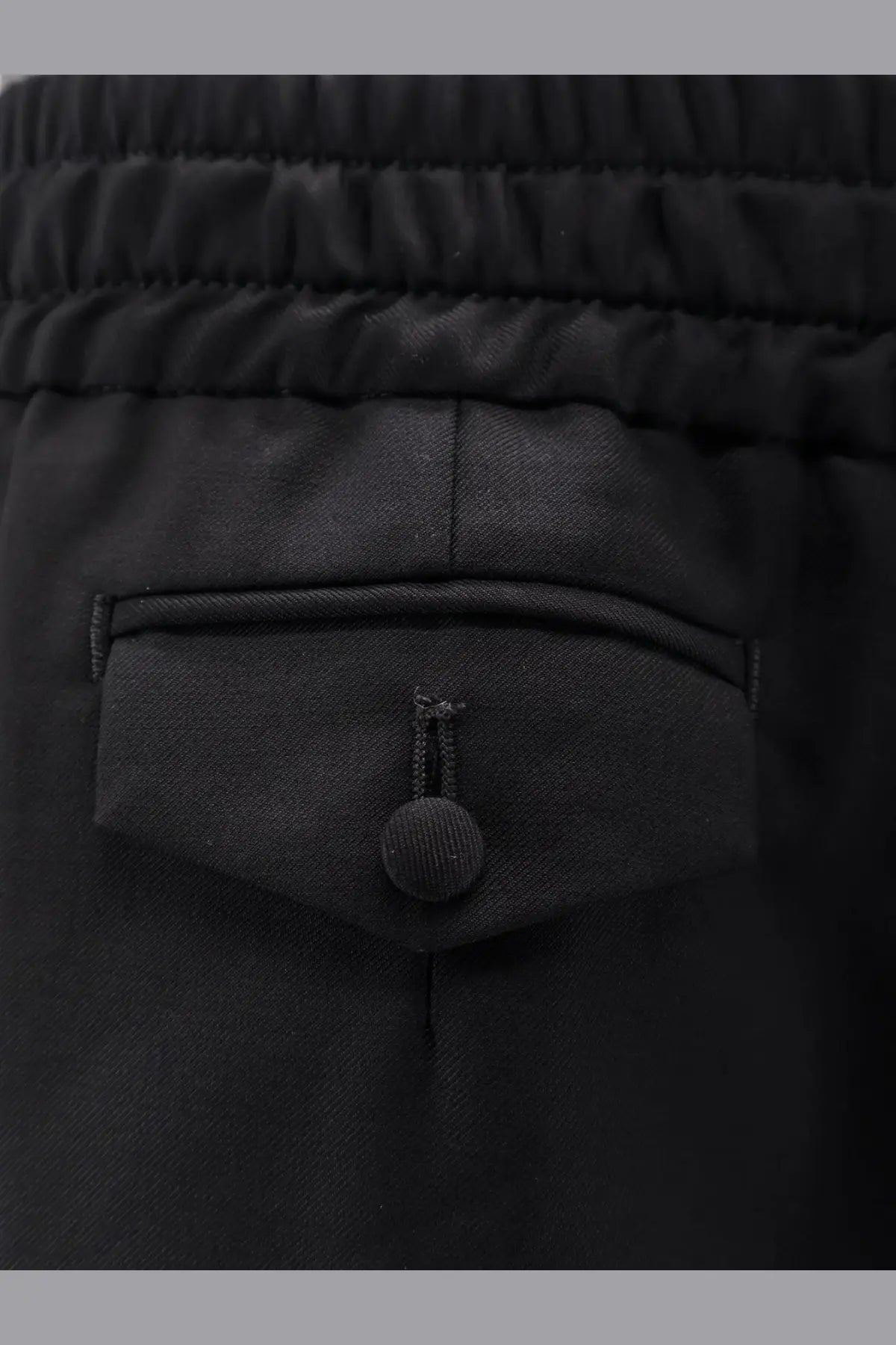 Dolce &amp; Gabbana men’s black virgin wool trousers with elastic waist textured fabric and front pocket button closure