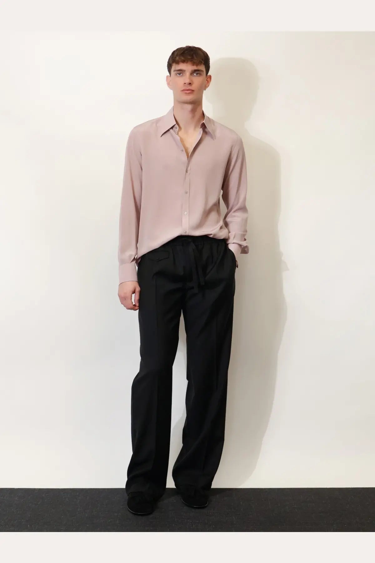 A soft blush pink long-sleeved button-down shirt with a classic collar paired with dolce &amp; gabbana men’s black virgin wool trousers