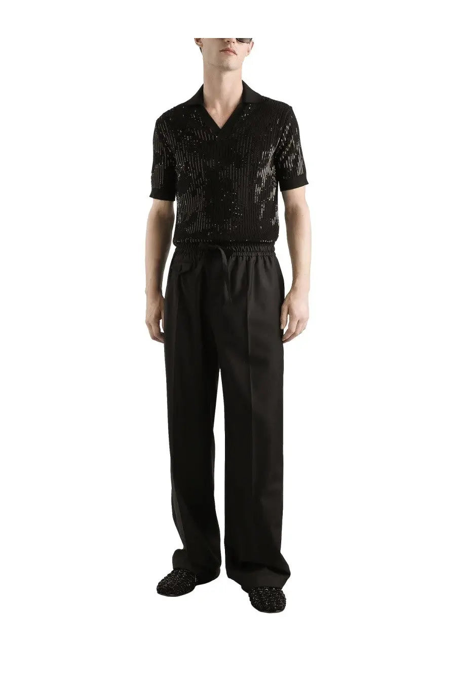 Black sequined short sleeve v neck shirt with subtle stripes paired with Dolce &amp; Gabbana men’s black wool knit jogging pants