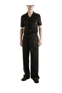 Black sequined short sleeve v neck shirt with subtle stripes paired with Dolce &amp; Gabbana men’s black wool knit jogging pants