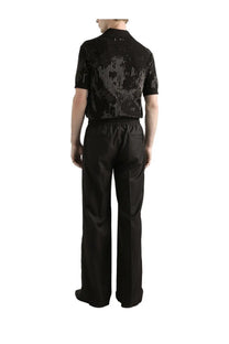 Black short-sleeved knit shirt with shimmering silver geometric pattern paired with dolce &amp; gabbana wool knit jogging pants