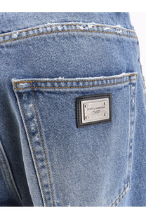 Back side of dolce and gabbana women’s blue denim jeans with distressed pocket and silver-tone milano italia label