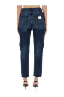 Dark blue denim dolce &amp; gabbana women’s boyfriend jeans back side with rectangular silver label on right pocket