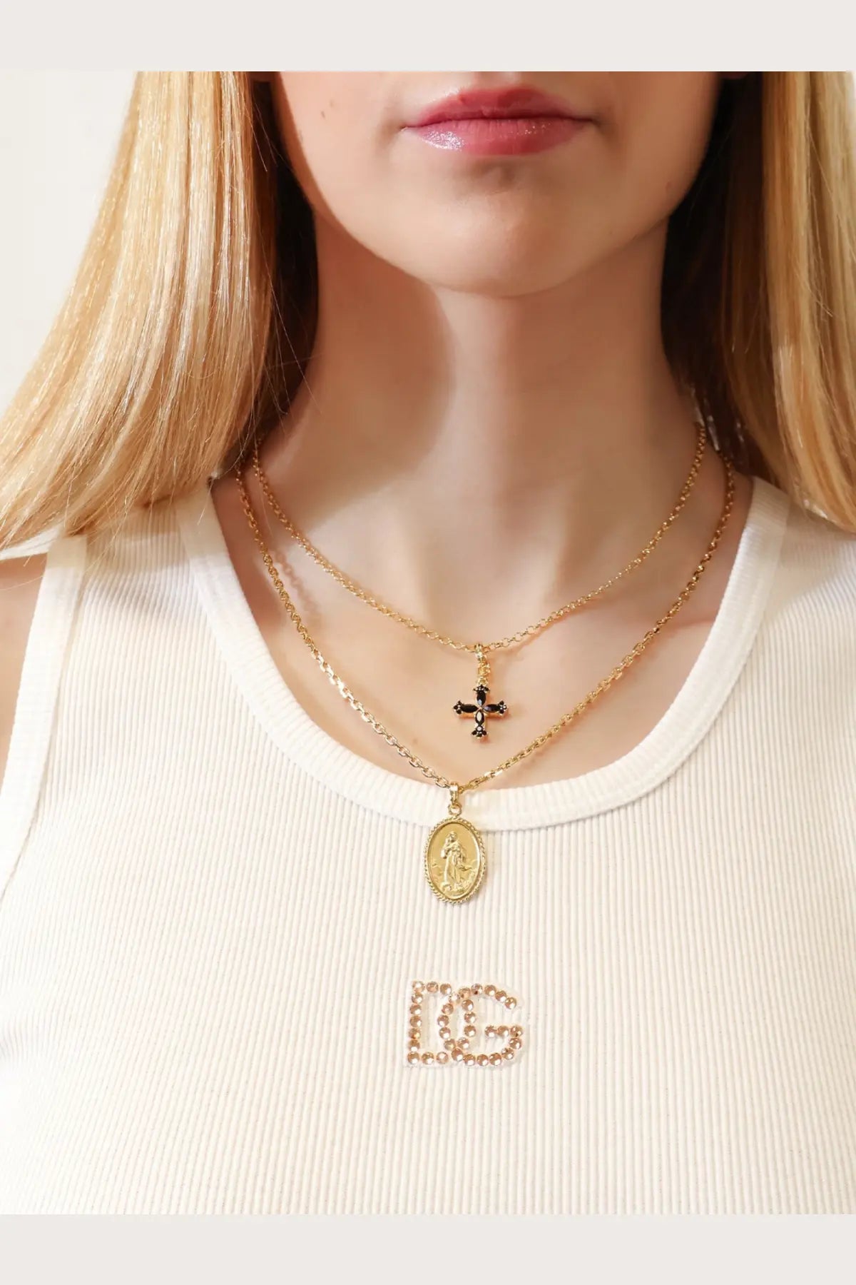 Dolce &amp; Gabbana women’s gold brass layered necklaces with black cross pendant and oval religious medallion