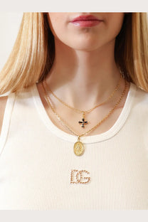 Dolce &amp; Gabbana women’s gold brass layered necklaces with black cross pendant and oval religious medallion