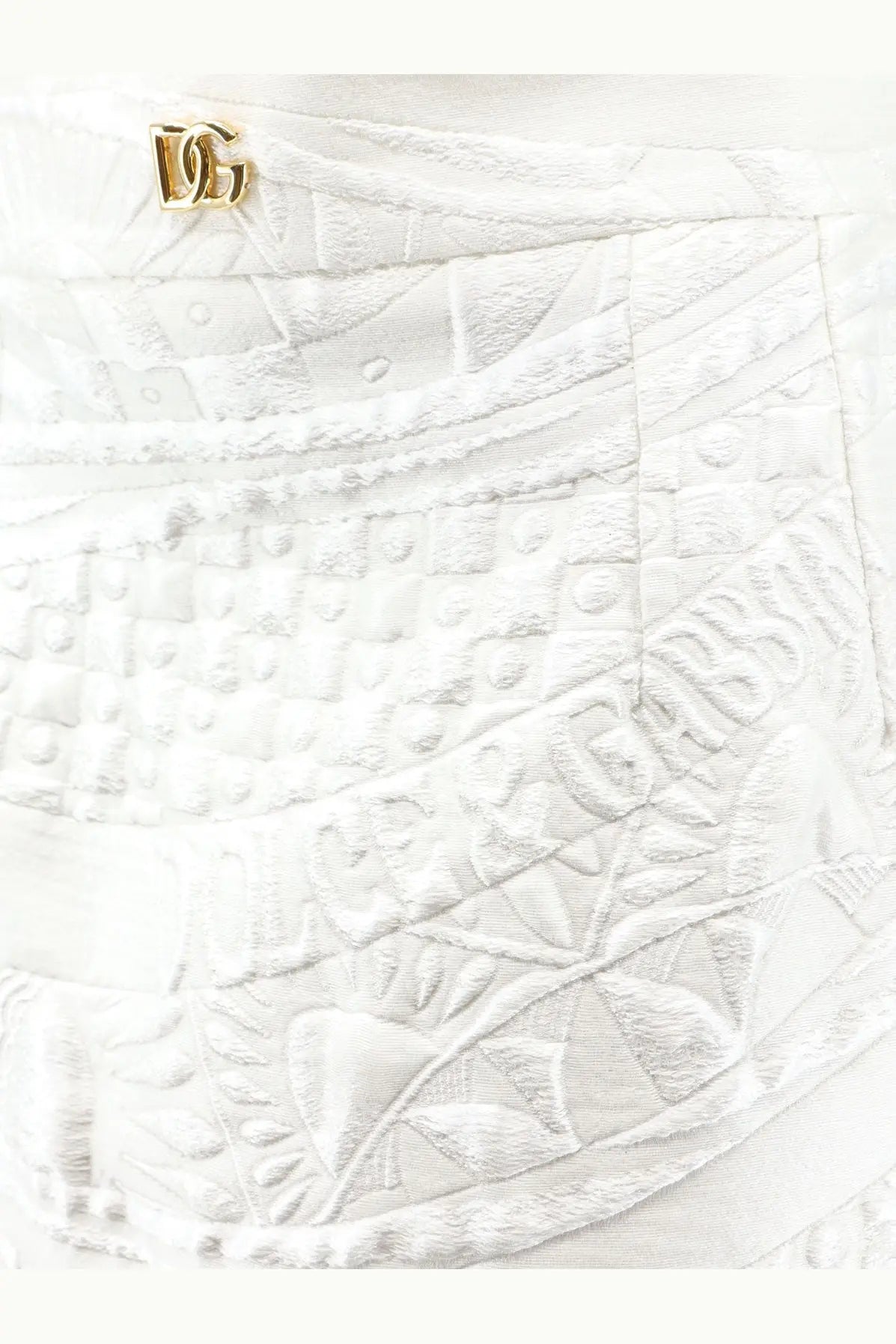 Dolce &amp; Gabbana women’s white brocade skirt with textured fabric embroidered patterns and gold-tone dg logo pin