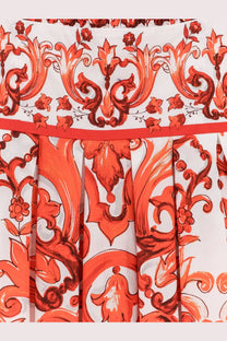 Dolce &amp; Gabbana women’s cotton long dress featuring a vibrant orange and white pleated skirt with baroque floral pattern