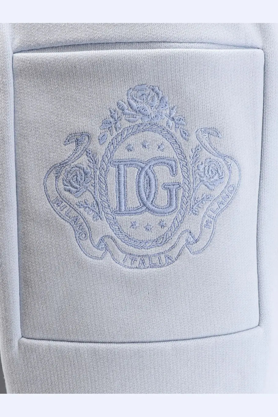 Light gray embroidered dg logo patch on soft cotton pocket of dolce &amp; gabbana women’s blue cotton trousers