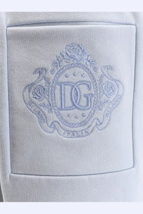 Light gray embroidered dg logo patch on soft cotton pocket of dolce &amp; gabbana women’s blue cotton trousers