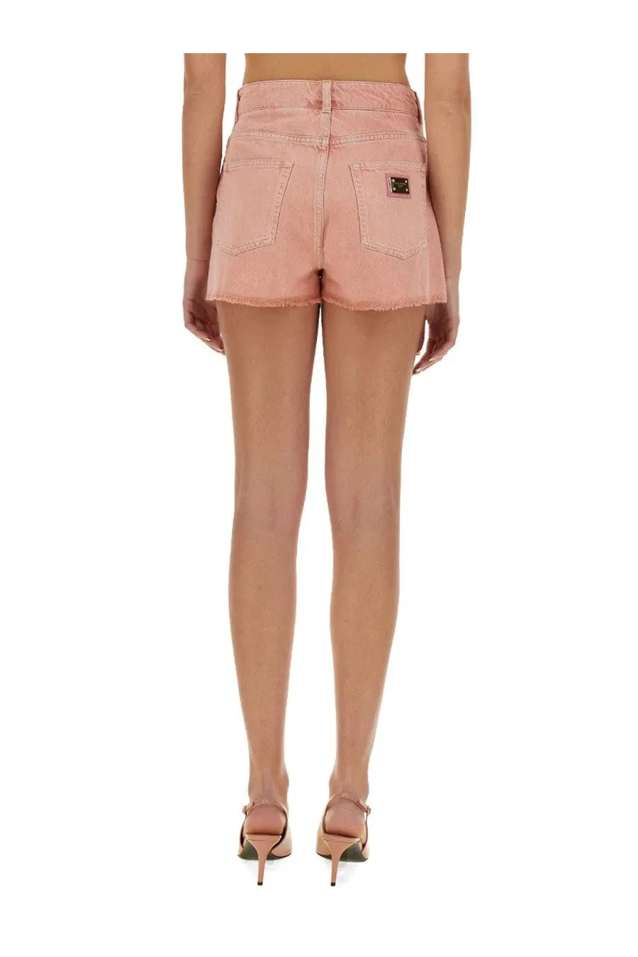 Dolce &amp; gabbana women’s pink denim shorts with frayed hem and black logo patch on the back right pocket