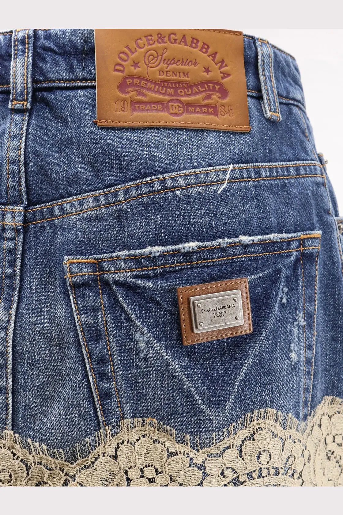 Dolce &amp; Gabbana women’s blue denim skirt with lace trim hem and brown leather branded patches on the back