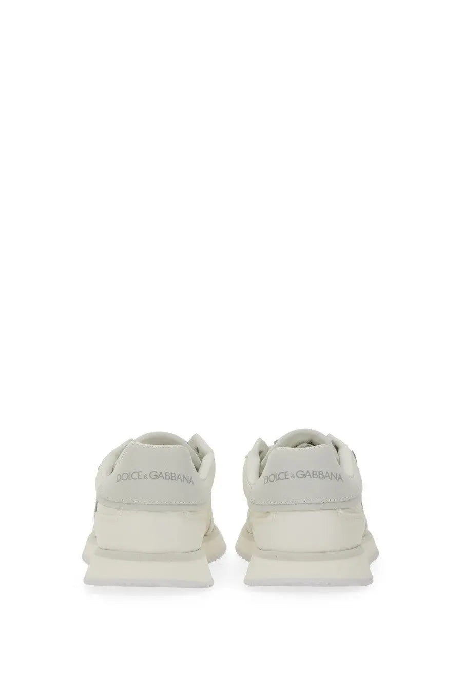 A pair of off-white dolce and gabbana women’s dg cushion sneakers with sleek modern design and chunky soles