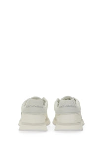 A pair of off-white dolce and gabbana women’s dg cushion sneakers with sleek modern design and chunky soles