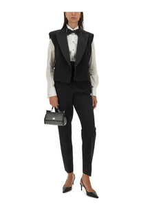 Black perforated leather handbag with silver hardware paired with dolce and gabbana women’s double breasted sleeveless jacket black