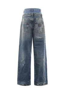 Back view of dolce &amp; gabbana women’s high-waisted wide-leg denim jeans in faded blue with distressed details and brand patch