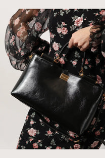 Dolce &amp; Gabbana women’s black patent leather crossbody bag with gold-tone hardware and rectangular plaque