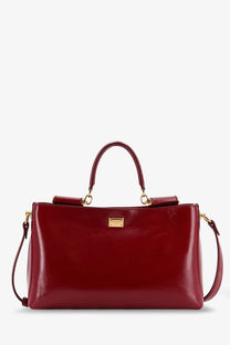 Dolce &amp; Gabbana women’s leather crossbody bag in glossy burgundy with gold-tone hardware and structured rectangular shape