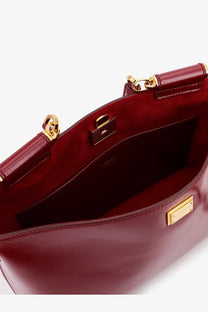Dolce &amp; Gabbana women’s rich burgundy leather crossbody bag with gold-tone hardware and structured interior