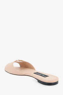 Beige leather dolce &amp; gabbana women’s slide sandal with gold-tone buckle detail and black rubber sole