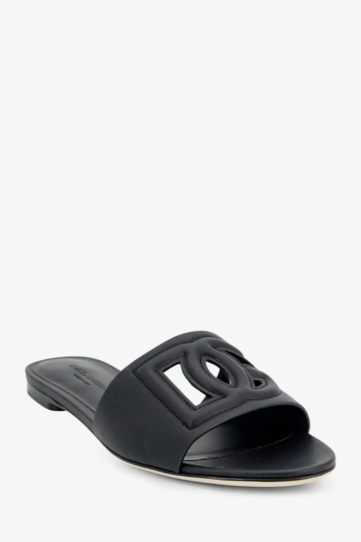 Dolce &amp; Gabbana women’s black leather slide sandal featuring an embossed interlocking CC logo on the upper