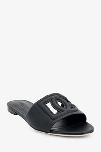 Dolce &amp; Gabbana women’s black leather slide sandal featuring an embossed interlocking CC logo on the upper