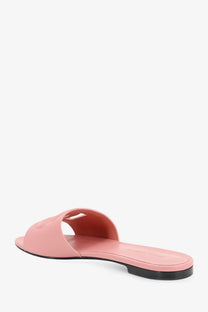 Dolce gabbana women’s pink leather slide sandal with black rubber sole and embossed logo on strap