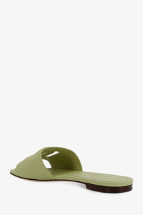 Dolce &amp; Gabbana women’s light green leather slide sandal with minimalist design and dark brown sole