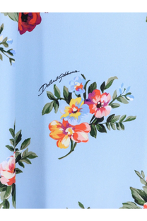 Dolce &amp; Gabbana women’s long charmeuse dress in light blue with vibrant floral print and green leaf accents